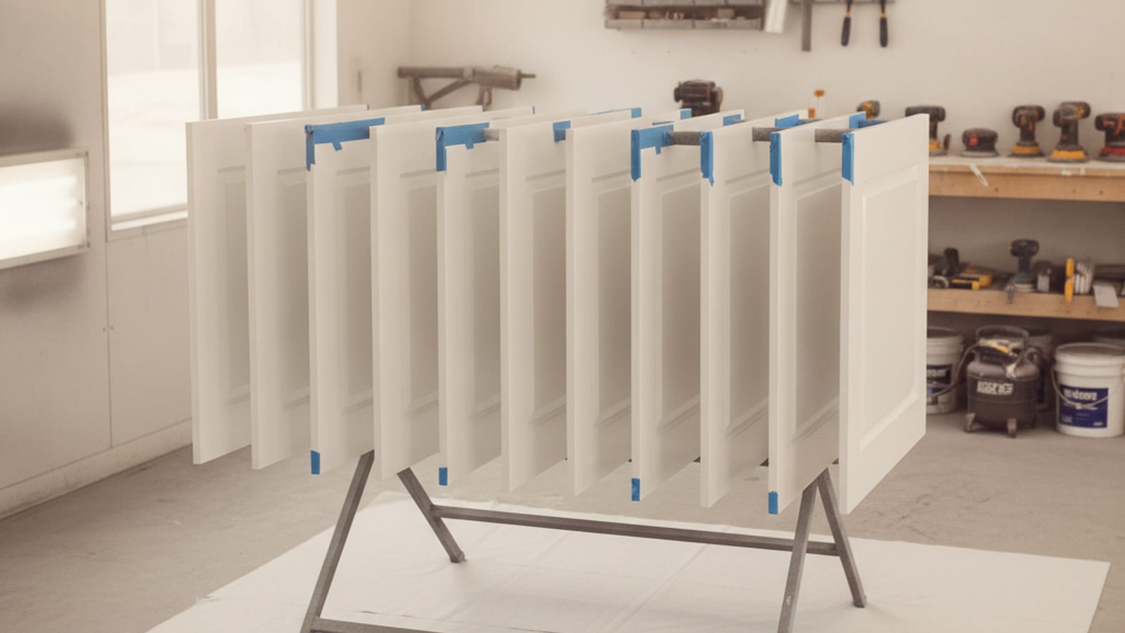 Sprayed white cabinet doors drying in a Tampa Bay paint shop before reinstall